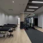 Row of treatment tables beside the clinic’s active rehab area